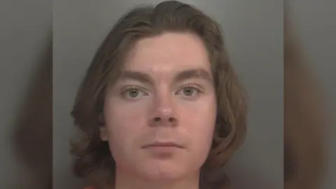 Merseyside Police Police mugshot of Louis McKechnie with long dark hair