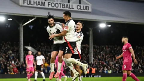 Dylan Martinez/PA Media Fulham's Raul Jimenez celebrates scoring their second goal with Rodrigo Muniz and Antonee Robinson against Town at Craven Cottage
