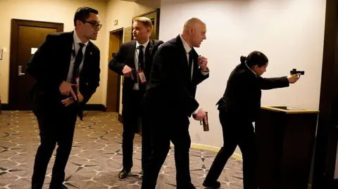 Getty Images Secret Service officers point pistols