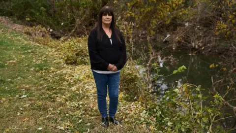 Theo Welling Karen stands in front of Nickel Coldwater Creek