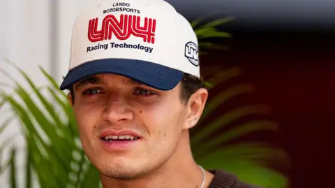 A close-up image of McLaren's Lando Norris wearing a cap at the United States Grand Prix