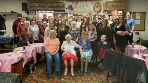 Family handout The whole family are pictured together sitting and standing in a large group photograph