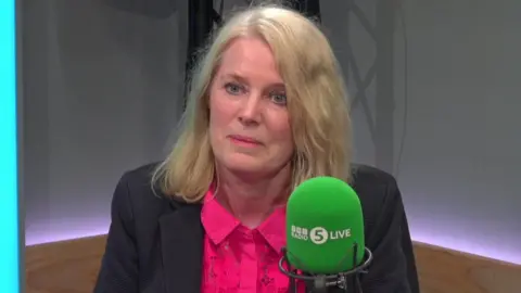Jo White in front of a BBC Radio 5 Live microphone in a studio.