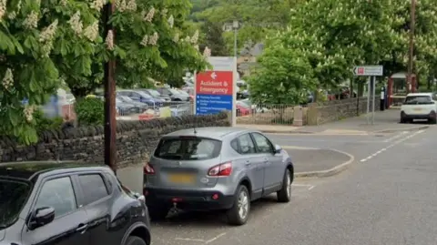 Google Two cars parked outside the A&E at Calderdale Royal Hospital. 