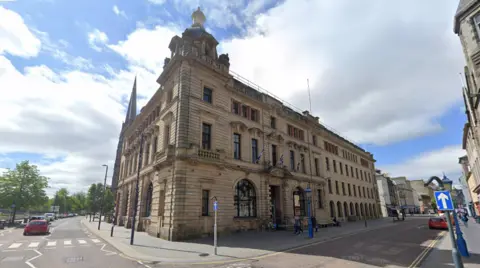 The exterior of Perth and Kinross Council's headquarters. A three-storey sandstone building on a corner 