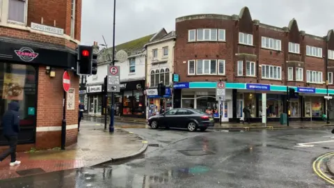 Vikki Irwin/BBC A picture of the corner of Dogs Head Street and Upper Brook Street. The traffic lights on red. 