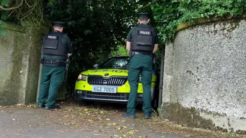 BBC Police and car at wall