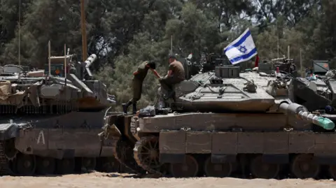 Reuters Israeli tanks wait near the Gaza border (May 29, 2024)