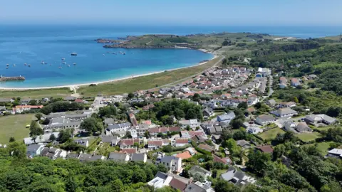 Drone shot of Newtown in Alderney with the sea in the background.