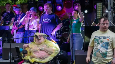 Barry Fahey Alt pop band Renegade Zoo are on stage - there are ten singers and musicians combined.