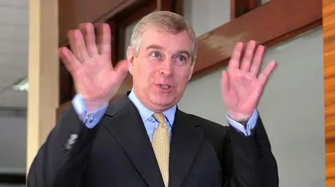 Getty Images Prince Andrew, the UK's trade representative, holds up his hands on a trade trip to Indonesia in 2011