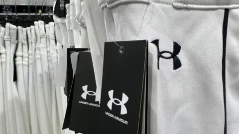 Getty Images A rack of white Under Armour jogging pants in a shop