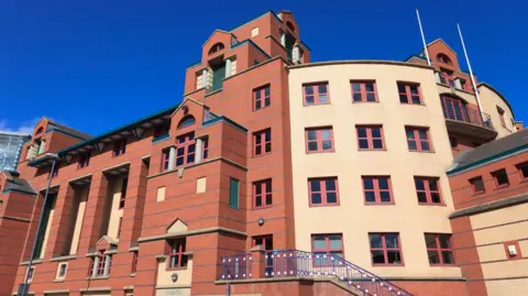 Leeds Magistrates' Court, a red and cream-coloured bricked building.