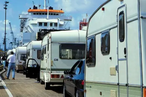 Portsmouth International Port Caravans line up to board a ferry in a photo from the 80s or 90s.