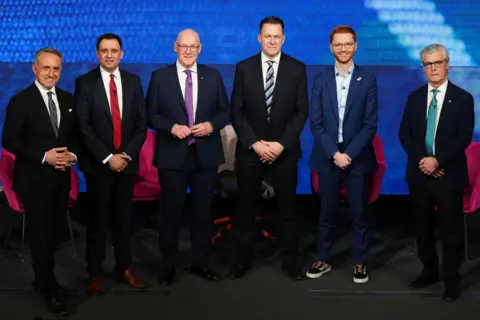 PA Media Alex Cole-Hamilton, Anas Sarwar, John Swinney, Russell Findlay, Ross Greer, Malcolm Offord wear suits and stand in a row