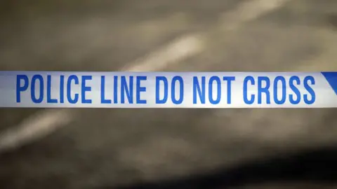 PA Police tape reading: Police Line do not cross.
