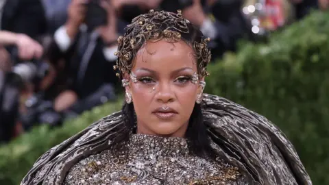 Rihanna is a silver, bejewelled outfit at the Met Gala.