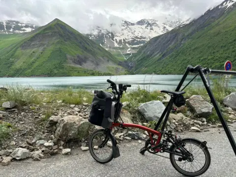 DAVID HOGG A foldable bike in front of a snowy mountain range