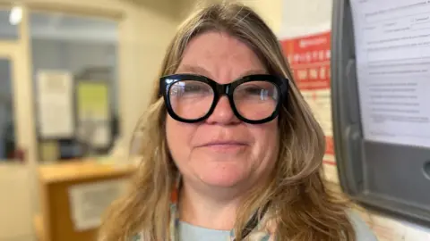 Sally is wearing glasses with large black frames