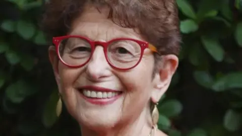 Julian Huppert Professor of psychology Felicia Huppert wearing red-framed glasses