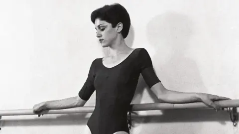Getty Images Madonna poses against a ballet barre during an early photoshoot in 1977