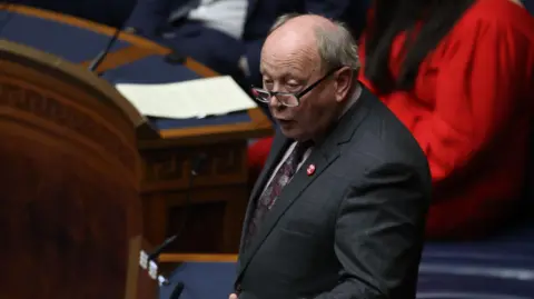 PA Media TUV leader Jim Alister speaking in the Northern Ireland Assembly