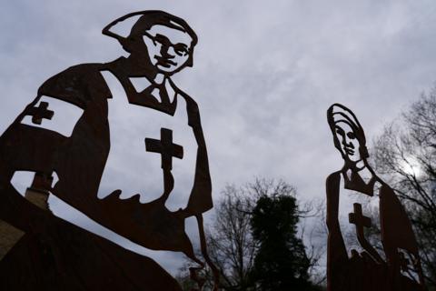 Giant silhouettes of the nurses who died in the D-Day campaignn