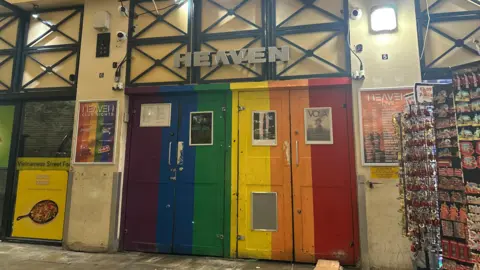 The Pride-themed doors of Heaven - the two doors are coloured purple, blue, green, yellow, orange and red. 