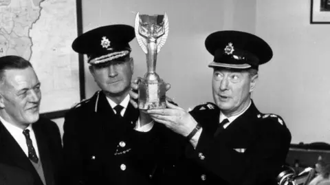 Getty Images Archive shot of two senior police officers holding the recently recovered Jules Rimet Trophy