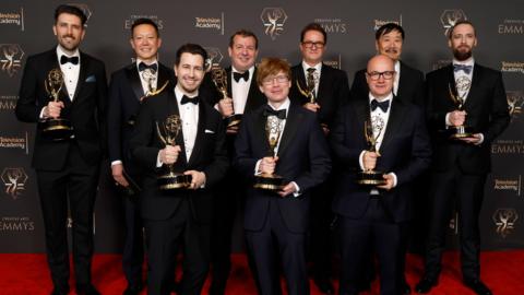 Nick Marshall, pictured with his team at the Emmys, all holding their awards
