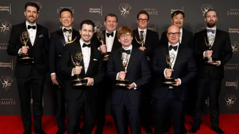 Nick Marshall, pictured with his team at the Emmys, all holding their awards