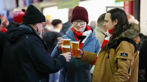 Aberdeen fans with pints of lager last season