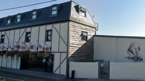 Exterior view of Titchfield Festival Theatre with mural of Shakespeare on the wall to the right