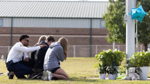 Getty Images Students at a makeshift vigil outside the school