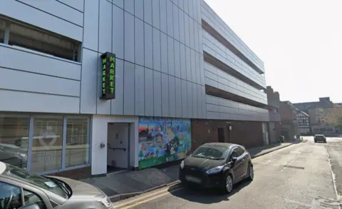 Google A street view of a building with the words market on the side