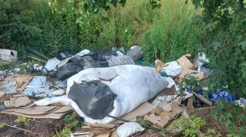 Cambridgeshire Police Flytipped items left near the bushes 