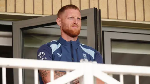 England captain Ben Stokes looks on from the balcony while his side lose to New Zealand
