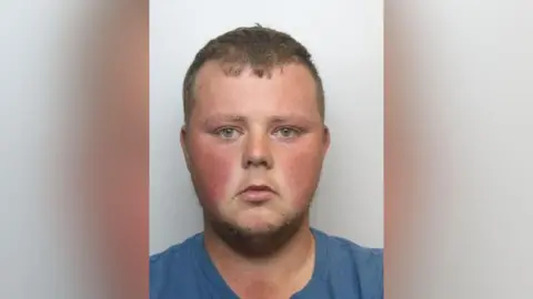 South Yorkshire Police A mugshot of Mason Reddy, looking at the camera and wearing a blue t-shirt