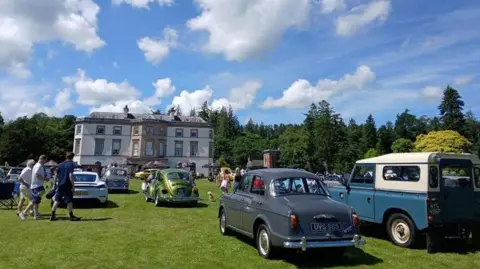BBC Weather Watcher John Vehicles parked in front of a large house, on the lawn at Montalto estate in County Down.