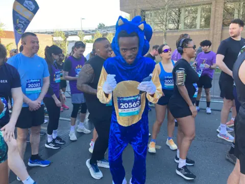 Yanick Maseko wears a velvet Sonic the Hedgehog costume