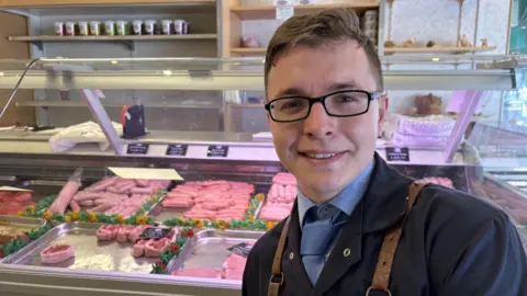 Man in front of produce