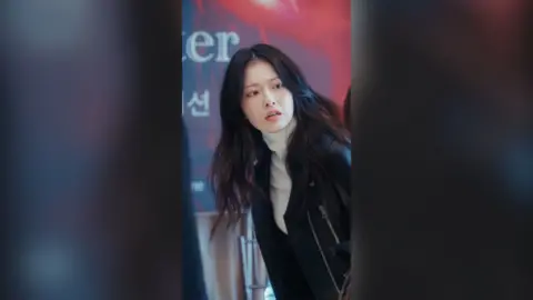 A South Korean actress with long dark hair. She is wearing a light grey polo neck and a black jacket with zips.