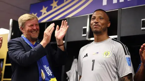 King Willem-Alexander of the Netherlands and Curacao goalkeeper Eloy Room