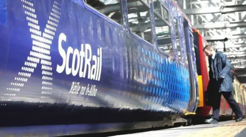 PA Media man boarding scotrail train