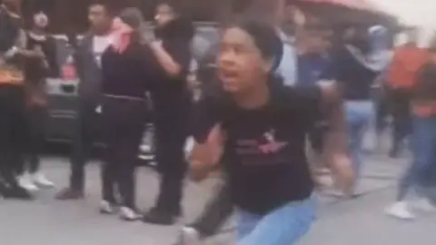 A girl runs from building damagd by earthquake in El Junquito near Caracas