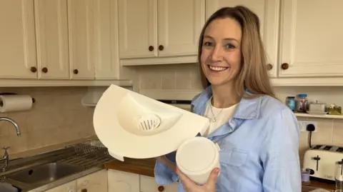 Laura with her Miscarriage Collection Cradle in kitchen.