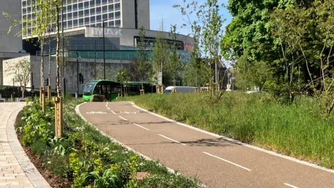 A cycle path leading up to an Imax cinema