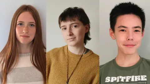 A montage of three young people, two girls and a boy. The girl on the left has long red hair and is wearing a pale white and grey jumper. The other girl, in the middle of the montage, is wearing a brown jumper and has short dark hair. The boy has black spikey hair. He is smiling and is wearing a dark green T-shirt with the word "spitfire" on it in white letters