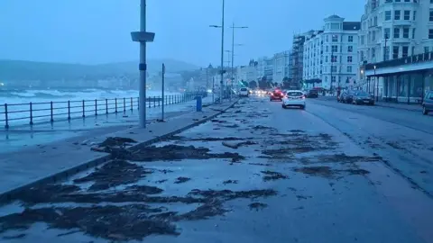 BAZ SYNMOTT Debris across the northern part of Douglas prom, there are some cars on the road.