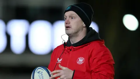 Lee Blackett on the field during a pre-game warm-up